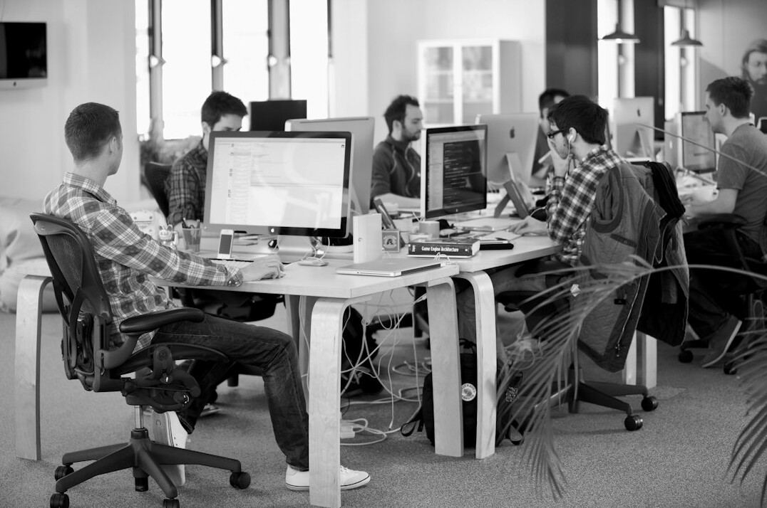 team of programmers collaborating in office