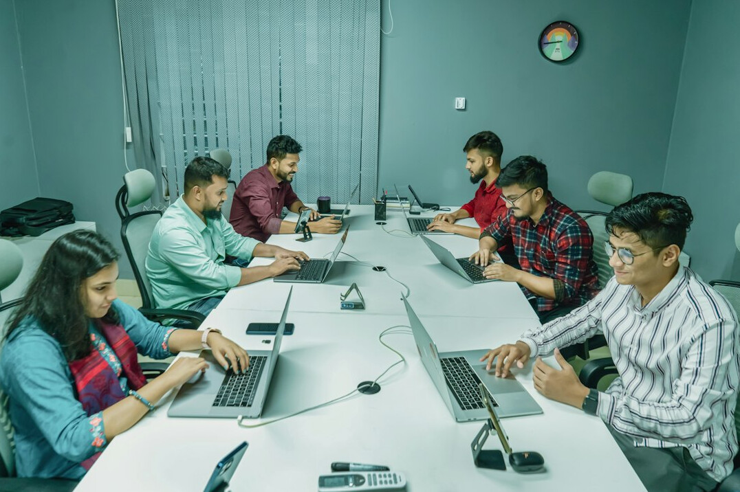 team of programmers collaborating in office